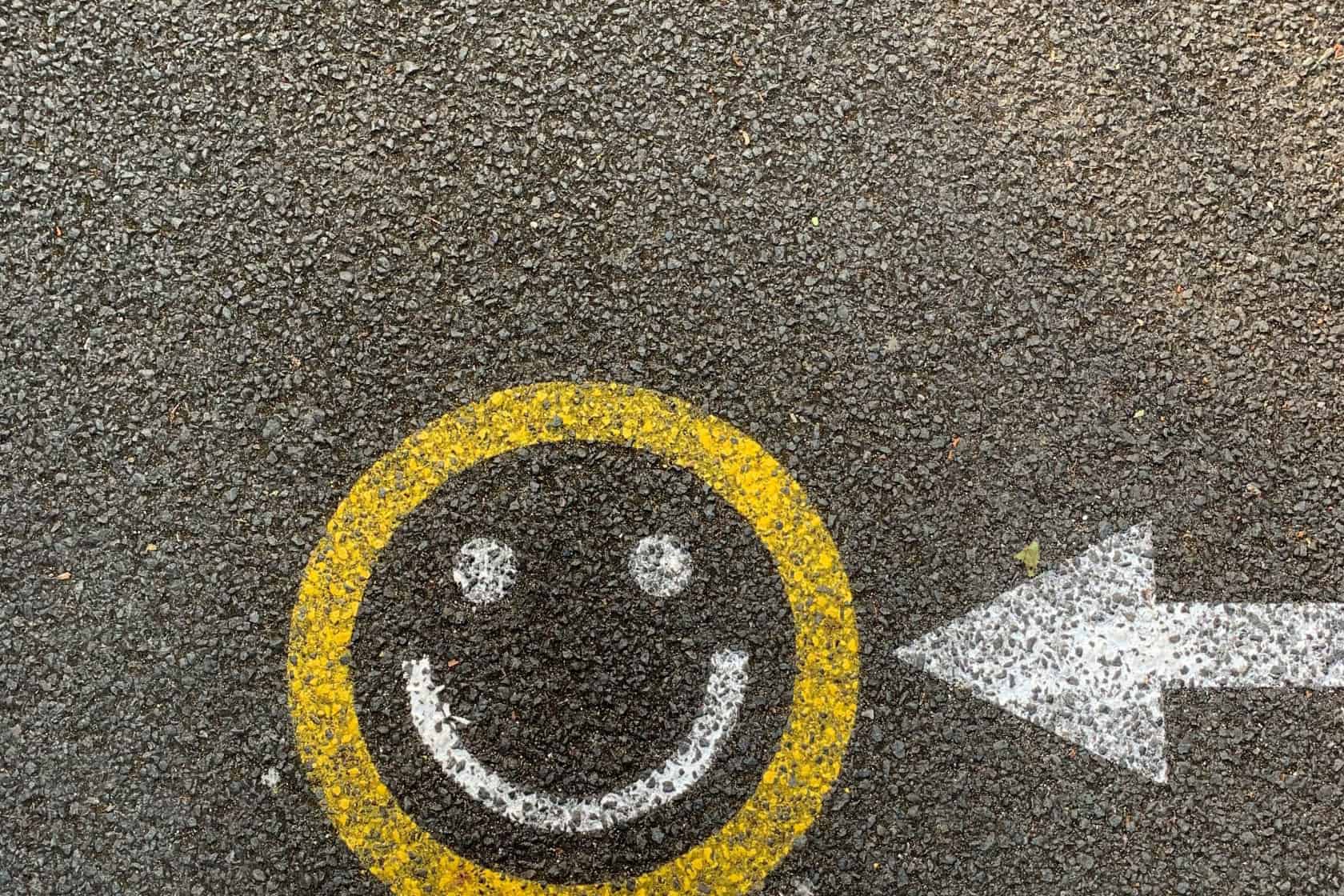 Are you happy with your productivity tool? Smiley face painted on the ground.